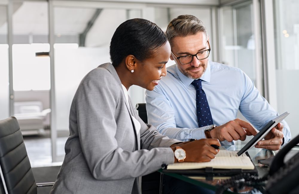Male and female colleagues reviewing documents 