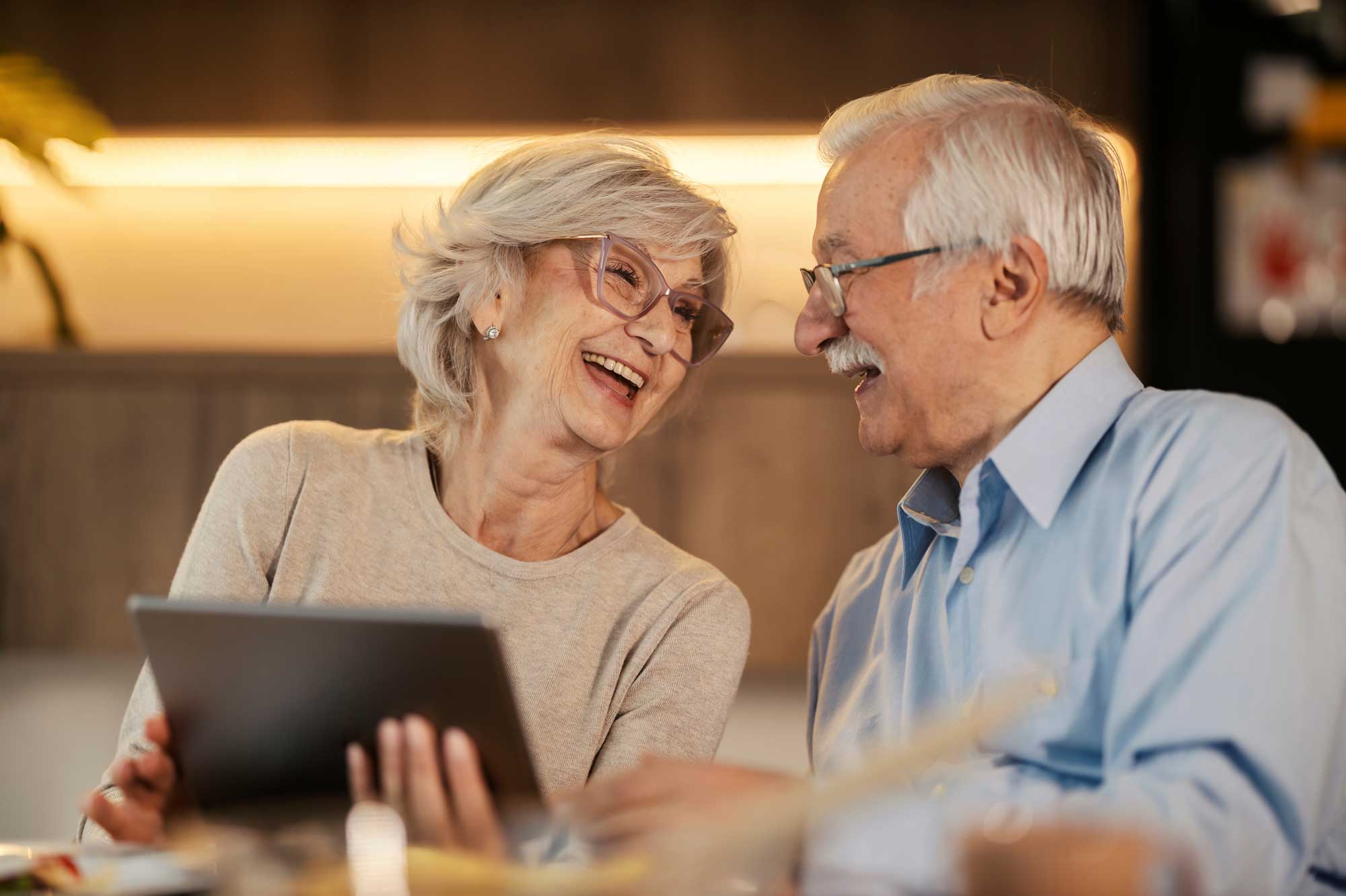 Cheerful senior have fun while taking selfie at retirement community