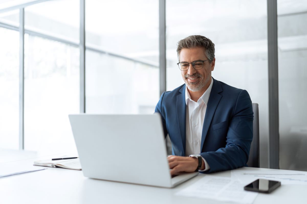 Male executive in his office looking at the laptop