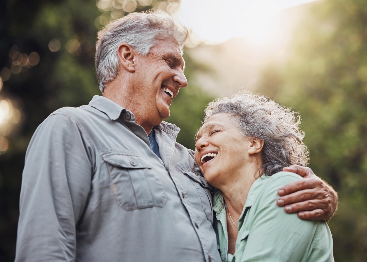 Senior couple, outdoor and laughing in nature
